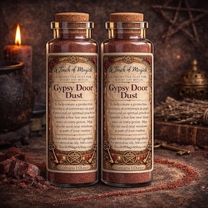 May include: Two glass bottles of Gypsy Door Dust with cork stoppers. Each bottle has a label with text that reads "A Touch of Magick" and "Gypsy Door Dust". The bottles contain 28 grams of dust. A lit candle and other items are in the background.