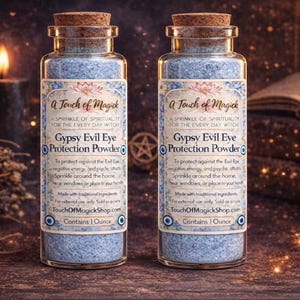May include: Two glass bottles with cork stoppers, filled with blue powder. Labels read "A Touch of Magick" and "Gypsy Evil Eye Protection Powder." Each bottle contains 28 grams of powder.