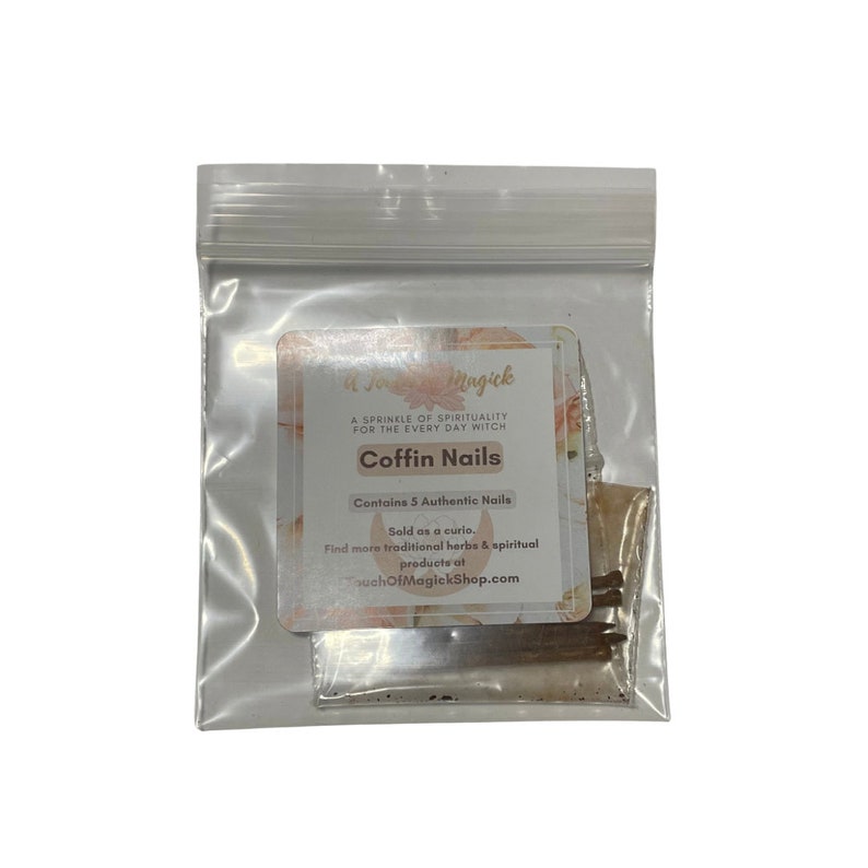 May include: A clear plastic resealable bag containing five dark brown metal nails. A white label on the front features the text: A Touch of Magick, A Sprinkle of Spirituality for the Every Day Witch, Coffin Nails, Contains 5 Authentic Nails.