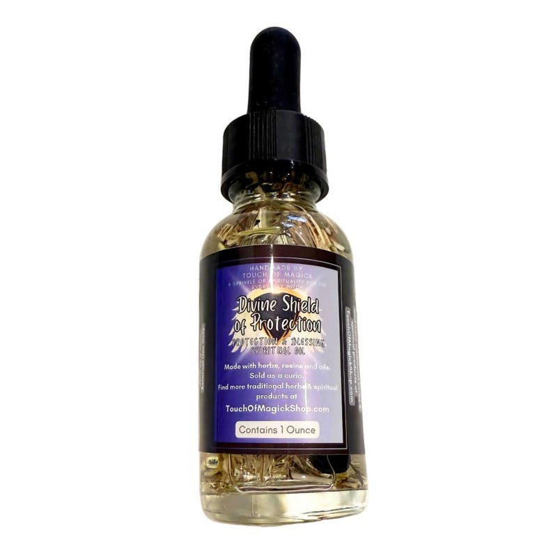 May include: A clear glass bottle with a black dropper filled with a golden liquid and herbs. The label reads "Divine Shield of Protection" and "Contains 1 Ounce". The bottle is for spiritual use.