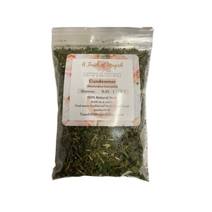 May include: A clear plastic bag filled with green herbs, labeled "Cundeamor" with the text "A Touch of Magick". The label also states "100% Natural Herb" and lists the weight in ounces.