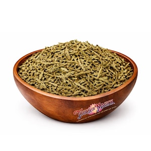 May include: A wooden bowl filled with dried, green herbs. The bowl has a rich, brown color and a smooth finish. The text "Touch of Magick" is printed on the side of the bowl, along with the phrase "A sprinkle of spirituality for the every day witch."