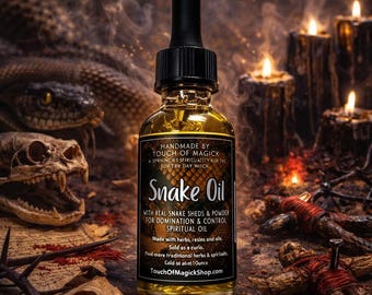May include: A bottle of Snake Oil with a black dropper, the label reads "HANDMADE BY TOUCH OF MAGICK". The bottle is surrounded by candles, a snake, and a skull. The text on the label says "WITH REAL SNAKE SHEDS & POWDER FOR DOMINATION & CONTROL SPIRITUAL OIL".