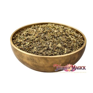 May include: A bronze-colored bowl filled with dried green herbs. The bowl has a rounded shape and a smooth surface. The text "Touch of Magick" is visible on the lower right corner, with the tagline "Sprinkle of Spirituality for the Every Day Witch".
