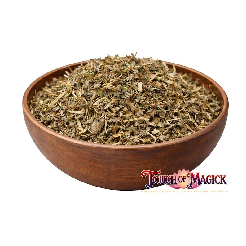 May include: A wooden bowl filled with dried herbs and leaves. The herbs are a mix of green and brown, with a textured appearance. The bowl is a warm brown color and has a smooth finish. The text "Touch of Magick" is visible in the bottom right corner.