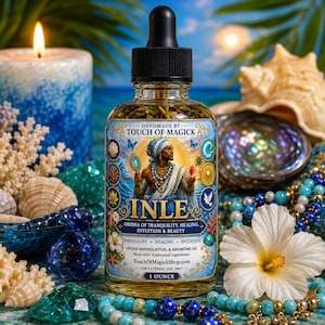 May include: A glass bottle of anointing oil with a black dropper, labeled "INLE" with an illustration of a figure. The label also reads "Orisha of Tranquility, Healing, Intuition & Beauty." The bottle is surrounded by seashells, crystals, and a lit candle.