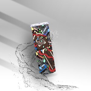 May include: A stainless steel tumbler with a colourful design featuring a clock, cassette tapes, and Christmas lights. The tumbler has a silver lid and is decorated with red ribbons. The background is white with water splashing.