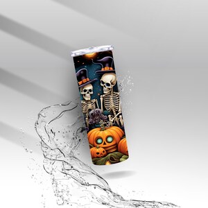May include: A Halloween-themed tumbler with a spooky design. The tumbler features two skeletons wearing witch hats, a glowing orange pumpkin, and a dark starry night background. The design is vibrant and detailed, perfect for Halloween.