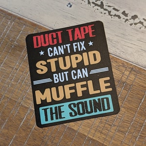 May include: Black and white sticker with the text "DUCT TAPE * CAN'T FIX * STUPID BUT CAN MUFFLE THE SOUND" in a bold, colorful font.