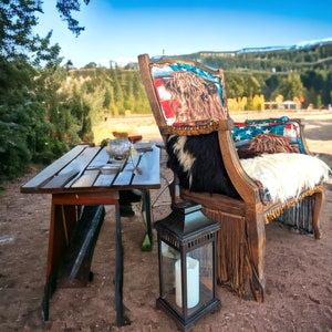 Elevate your farmhouse decor with this stunning Western Style Brown Leather Chair, a perfect blend of rustic charm and vintage appeal. Crafted from reclaimed wood and upcycled materials, this unique piece features a distressed brown leather frame that exudes cowboy cool. The upholstery is adorned with a striking Highland cow print, adding a touch of countryside authenticity, while the goat-skin hides drape gracefully over the seat, offering both comfort and texture.