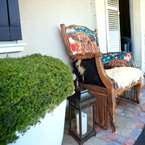 Elevate your farmhouse decor with this stunning Western Style Brown Leather Chair, a perfect blend of rustic charm and vintage appeal. Crafted from reclaimed wood and upcycled materials, this unique piece features a distressed brown leather frame that exudes cowboy cool. The upholstery is adorned with a striking Highland cow print, adding a touch of countryside authenticity, while the goat-skin hides drape gracefully over the seat, offering both comfort and texture.