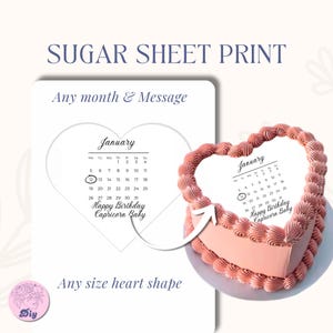 May include: A heart-shaped cake with pink frosting and a sugar sheet print. The print features a January calendar, highlighting the 12th, and the text "Happy Birthday Capricorn Baby." The image also shows a sample print.