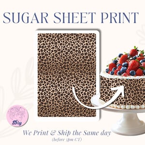 May include: A sugar sheet print with a leopard print design. The image shows a rectangular sheet with the same pattern, and a cake decorated with the same leopard print, topped with strawberries and blueberries.