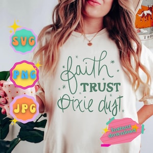 May include: A white sweatshirt with the text "faith trust dixie dust" in green script. The text is surrounded by small stars. The sweatshirt is being worn by a person. The image also includes three colorful buttons labeled "SVG", "PNG", and "JPG".