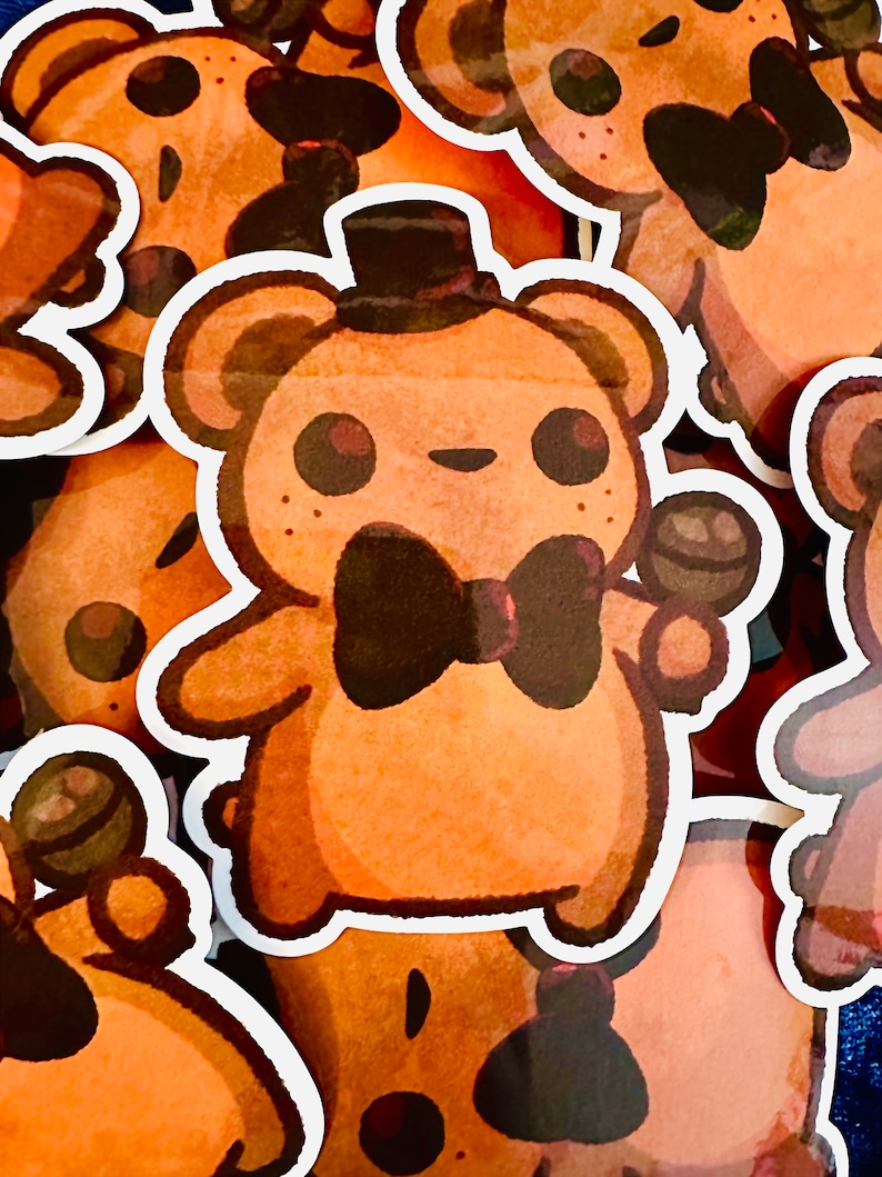 May include: A set of brown bear stickers with black bow ties. The bears are wearing hats and holding a microphone. The stickers are on a blue background.