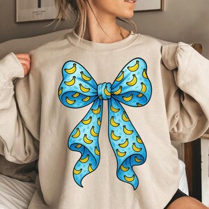 Bananen Druck Schleife PNG | Niedliches blaues Band mit Obstmuster Wunderliche transparente Grafik für Kinder, Handwerk & Bekleidung