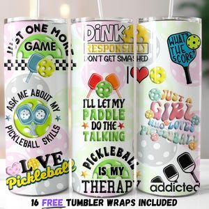May include: Three pink and white tumbler wraps with pickleball designs. The first wrap says "Just One More Game Ask Me About My Pickleball Skills Love Pickleball". The second wrap says "Dink Responsibly Don't Get Smashed I'll Let My Paddle Do The Talking Pickleball Is My Therapy". The third wrap says "What's The Score? Just A Girl Who Loves Pickleball Addicted".