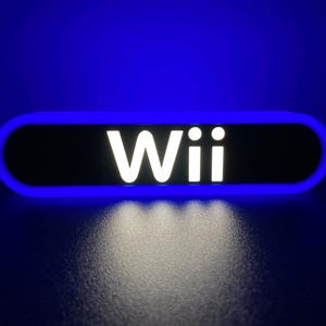 May include: A blue and black sign with the word "Wii" in white letters.