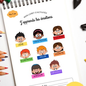 May include: A colorful activity book for 2-year-olds titled "J'apprends les &eacute;motions" (I learn emotions) with illustrations of different facial expressions and corresponding French words for emotions like joy, sadness, anger, surprise, fear, shame, love, and disgust. The book has 37 pages, including 7 annexes and 12 different games.