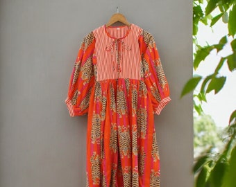 May include: A long, orange and pink dress with a white striped bodice and a tiger print skirt. The dress has a tie at the neckline and puffed sleeves.