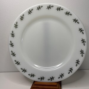 May include: White ceramic dinner plate with a black leaf design around the rim.