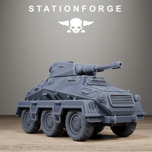 May include: A gray resin model of a six-wheeled armored combat vehicle featuring a rotating turret with a mounted cannon, front grille, and headlights. The text STATIONFORGE and a skull logo are positioned above the vehicle in white.