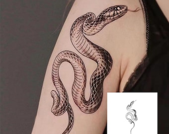 May include: A black and grey snake temporary tattoo design on an arm. The snake is coiled and has a textured pattern. A smaller version of the snake design is in the corner.