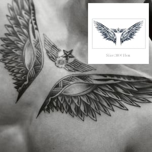 May include: A temporary tattoo with a detailed design of two black and white wings with a star in the center. The tattoo is 30 x 15 cm.
