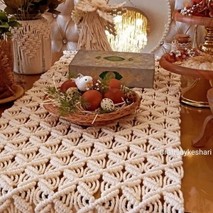 May include: A white crocheted table runner with a geometric pattern. The runner is decorated with a nest of quail eggs and a small white bird figurine. The text "Craftsbykeshri" is visible in the bottom right corner of the image.