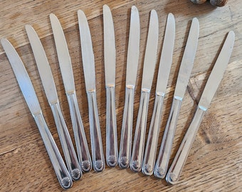 Set of 10 vintage stainless steel serrated knives with Saint Jacques decor