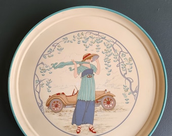 Vintage round tray decorated with a woman in a hat and her car, 1920s in thick plastic