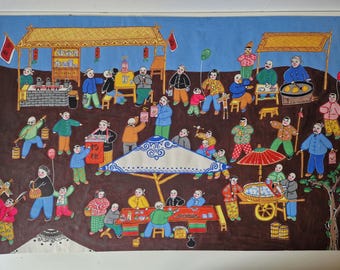May include: A colorful folk art painting depicting a bustling outdoor market scene with numerous figures in traditional clothing, food stalls, a large central umbrella, and a cart. The artwork features vibrant red, blue, and yellow tones.