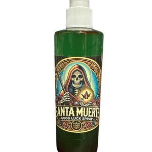 May include: Green liquid spray bottle with a white sprayer. The label features a colourful illustration of a skeleton figure with the words "SANTA MUERTE GOOD LUCK SPRAY". The bottle is designed for good luck.