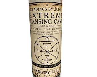 May include: A tall cylindrical glass candle with a white wax interior. The label features the text READINGS BY JUDIE EXTREME CLEANSING CANDLE, a circular geometric sigil, and the website READINGSBYJUDIE.COM with the phone number 877-377-5512.
