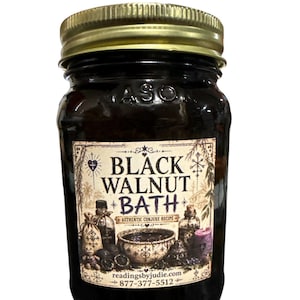 May include: A glass jar with a gold lid filled with a dark liquid. The label reads "Black Walnut Bath" with illustrations and text. The jar is labeled "ASO" on the glass.
