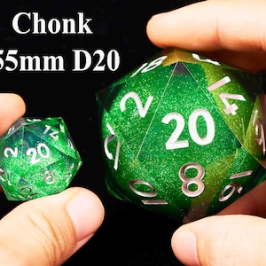 May include: Two green D20 dice with white numbers. The larger die is 55mm and has a glittery finish. The smaller die is a standard size.