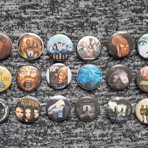 Horror movie covers, one inch pins or magnets sets, keychains, zipper pulls, mystery packs, classic horror comedy, movie lovers