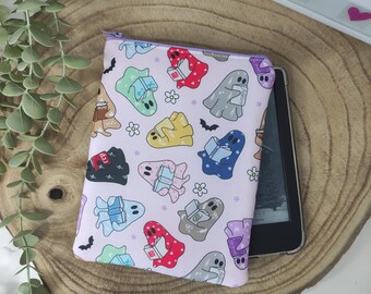 May include: A pink zippered pouch with a repeating pattern of ghosts reading books. The ghosts are various colors, including red, blue, green, yellow, and purple. The pouch is perfect for storing small items like electronics, makeup, or jewelry.