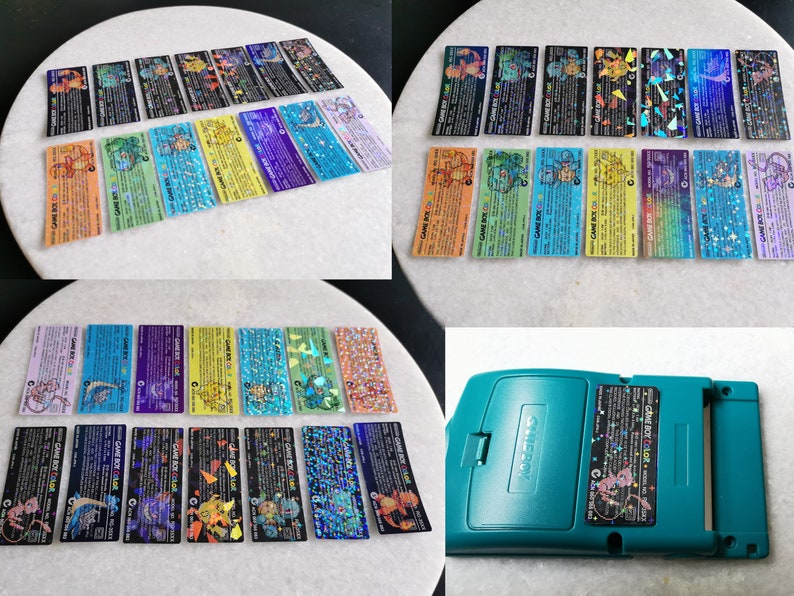 May include: A collection of 16 holographic Pokemon Game Boy Color game cards featuring various Pokemon characters. The cards are arranged in two rows of eight cards. The cards are all different colors and have a holographic finish. The cards are all in good condition.  The cards are displayed on a white surface.  A teal Game Boy Color game console is also shown in the image.