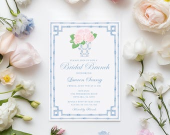 May include: A blue and white invitation for a bridal brunch honoring Lauren Searey. The invitation features a blue and white floral illustration and a bamboo-style border.