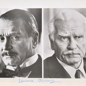 May include: Black and white photograph featuring two portraits of a distinguished older man. The man on the left has dark hair and a mustache, wearing a bow tie. The man on the right has white hair and a mustache, wearing a tie. The signature "Laurence Olivier" is at the bottom.
