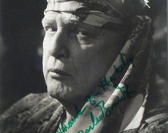 May include: Black and white photo of a man with a bandana on his head. He is looking to the side and has a serious expression on his face. The photo is signed "Thanks for the help,  Marlon Brando".