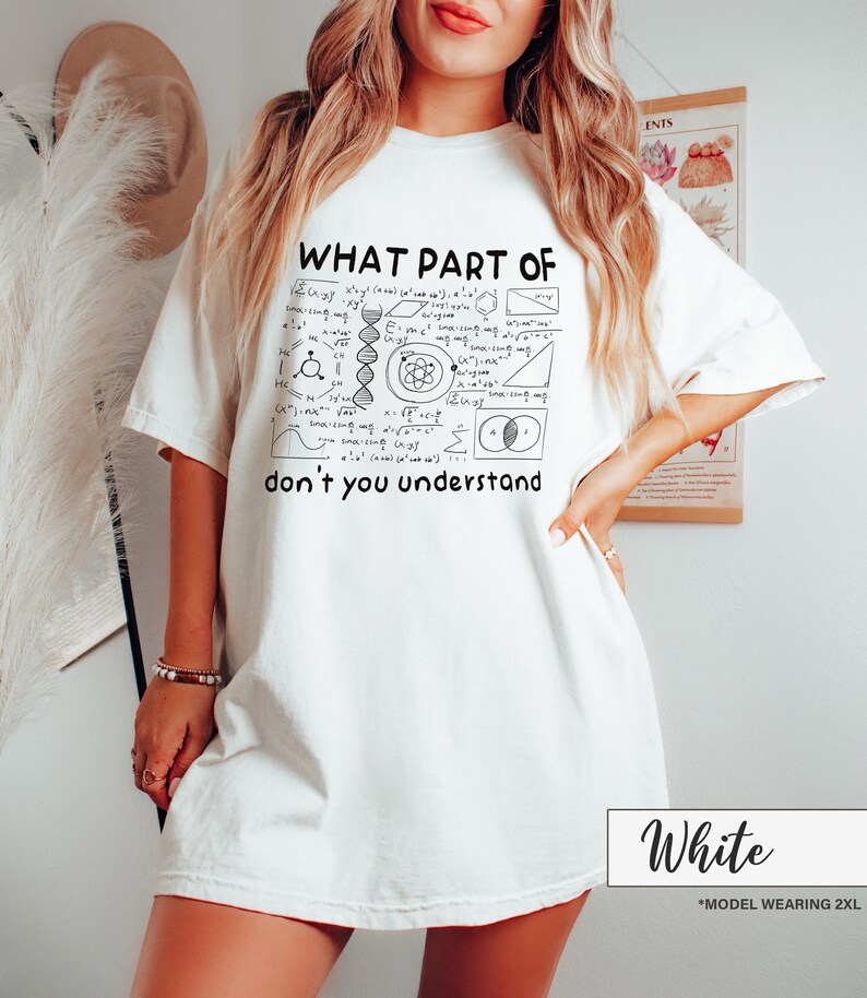 May include: White t-shirt with the text "WHAT PART OF don't you understand" and a black and white graphic of mathematical and scientific symbols. The shirt is a relaxed fit.