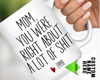 May include: White ceramic mug with the text "MOM. YOU WERE RIGHT ABOUT A LOT OF SHIT" in black. A red heart and the name "EMMA" are below the text. The mug is labeled "15 OZ MUGS". A custom name tag is visible.
