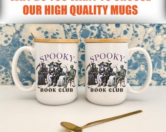 May include: Two white ceramic mugs with wooden lids, featuring a spooky book club design with various Halloween characters. The mugs have large handles and the text "SPOOKY BOOK CLUB". A gold spoon rests in front of the mugs. The text "WHY DO YOU WANT TO CHOOSE OUR HIGH QUALITY MUGS" is at the top.