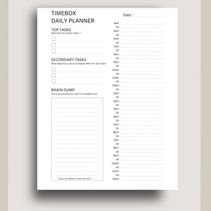 May include: A black and white daily planner with the title "TIMEBOX DAILY PLANNER". The planner has sections for "TOP TASKS", "SECONDARY TASKS", and "BRAIN DUMP". The planner also has a time slot section from 4am to 12am.