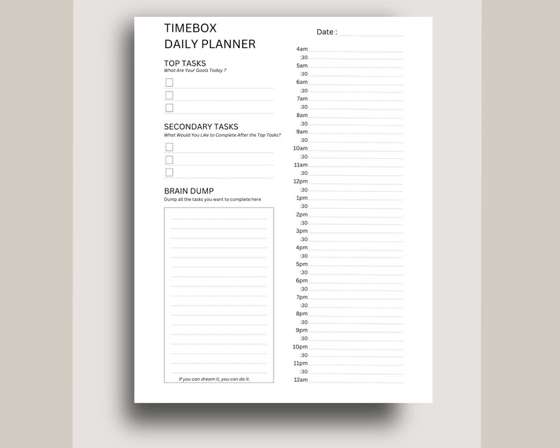 May include: A black and white daily planner with the title "TIMEBOX DAILY PLANNER". The planner has sections for "TOP TASKS", "SECONDARY TASKS", and "BRAIN DUMP". The planner also has a time slot section from 4am to 12am.