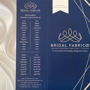 May include: A blue and gold business card with the text "Bridal Fabrica" and the tagline "Bridal Fabrics Import & Export. To Turn Dreams Into Reality, Reality Into Dreams". The card also lists a variety of fabrics and tulle for bridal gowns.