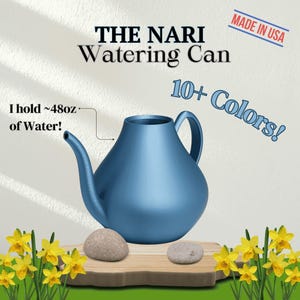 May include: A blue watering can with a spout and a handle. The can is sitting on a wooden surface with two small rocks. The text "THE NARI Watering Can" is at the top of the image. The text "I hold ~48oz of Water!" is on the left side of the image. The text "10+ Colors!" is on the right side of the image. The text "MADE IN USA" is in a red rectangle at the top right of the image.