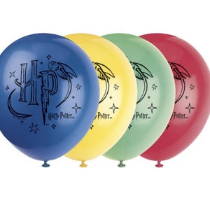 May include: Four round balloons in blue, yellow, green, and red. Each balloon has a black graphic of the Harry Potter logo and text. The balloons are inflated, ideal for a party or celebration.